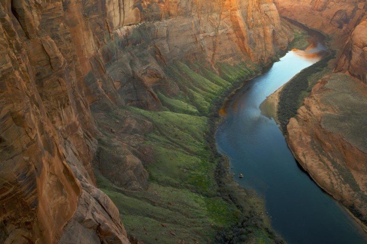 bend in the colorado river with orange canyon rising above