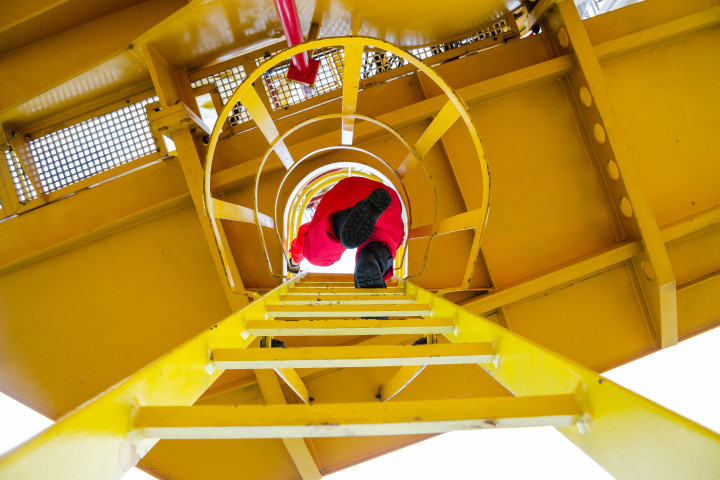 offshore oil rig worker climbing