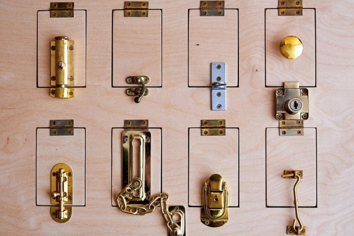 eight different locks on a slab of wood