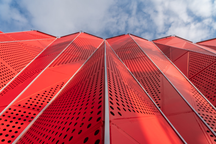 red steel structure facade with holes