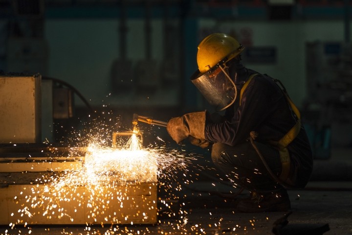 welder welding steel in workshop