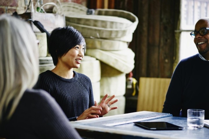 diverse group of three executives having conversation