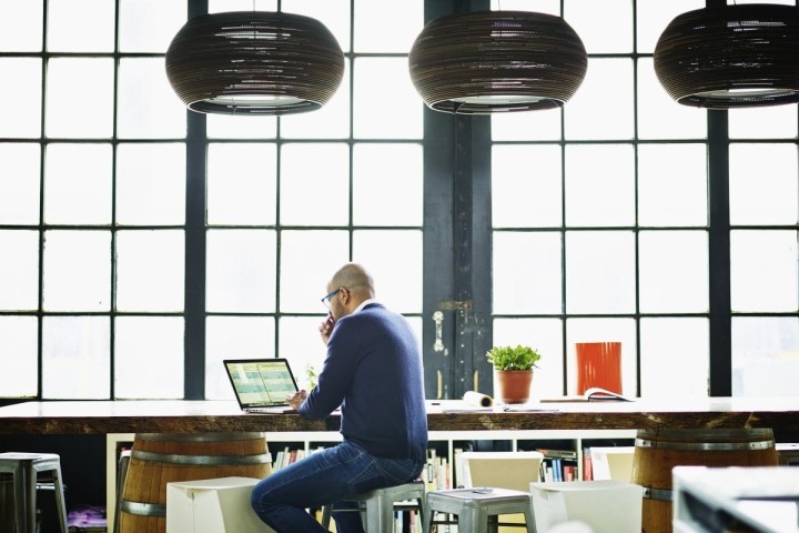 business owner in studio office working on spreadsheet