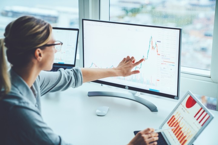 /sites/default/files/article-images/GettyImages-1170740Business woman study financial market to calculate possible risks and profits