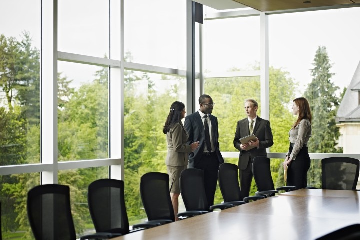 coworkers standing in conference room