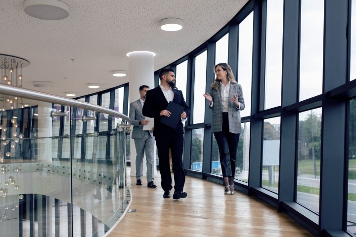 group of corporate business colleagues walking along the corridor