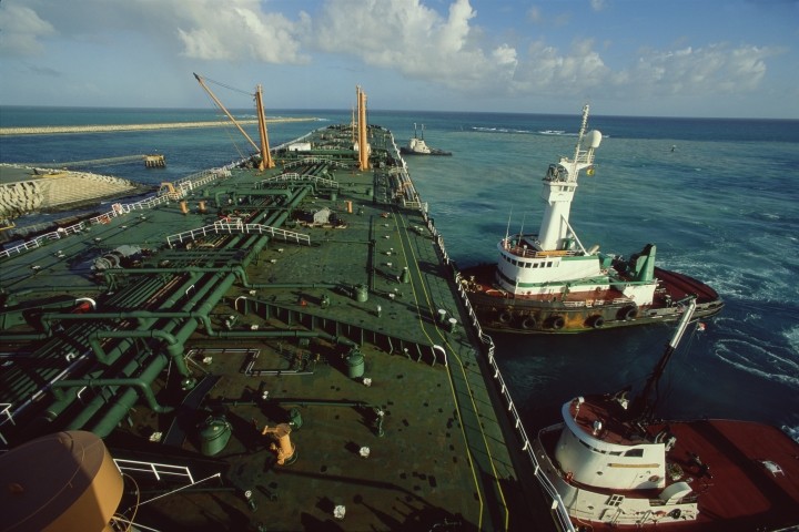 elevated view of oil tanker ship and tugboats