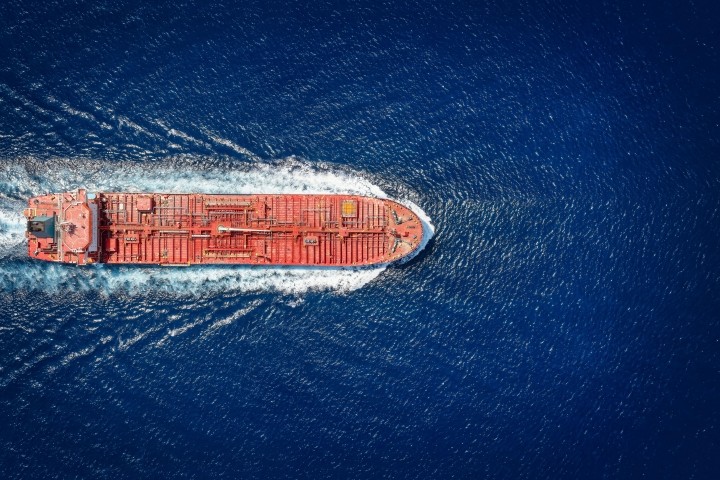 high aerial top view of a crude oil tanker traveling with speed