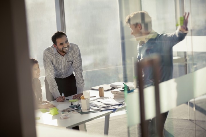 business colleagues smiling in planning meeting 