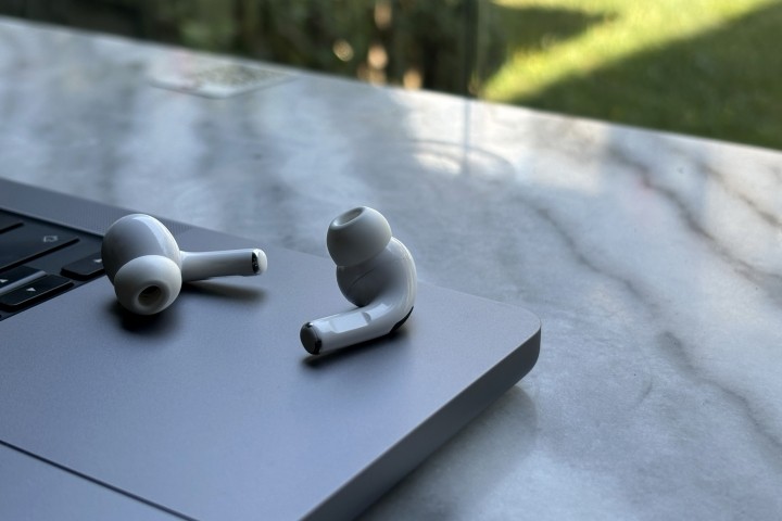 airpods resting on laptop on outside table