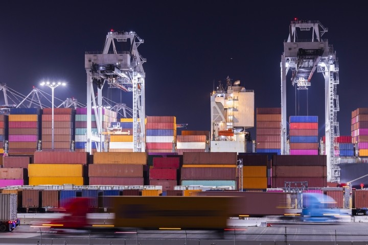brightly colored shipping containers on dock at night