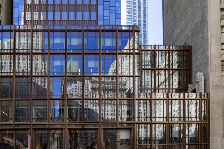 buildings in lower manhattan reflected in windows