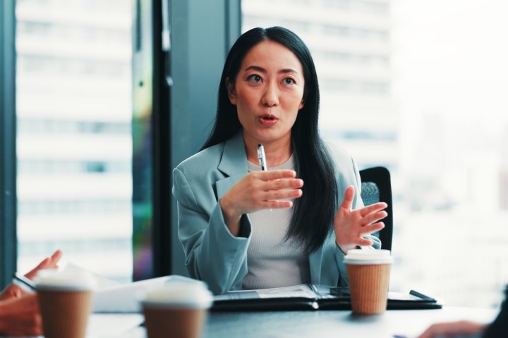 female board director engaged in conversation in conference room