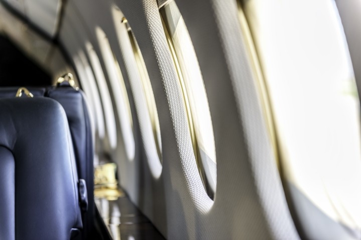 interior of private jet with blue seats