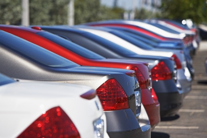 closeup of red white and blue cars on a lot