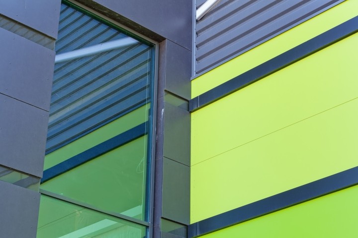 close up of bright blue and lime aluminum facade on industrial building