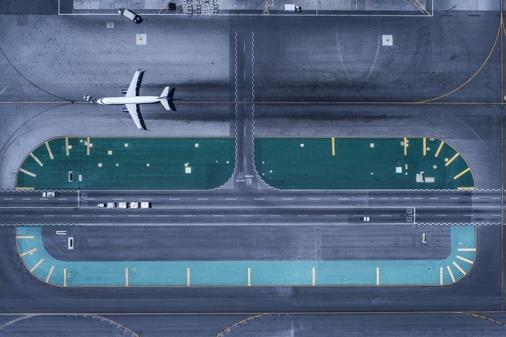 overhead view of runway at lax airport with one airplane