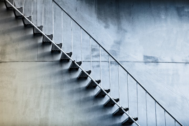 simple metal stairs against concrete wall