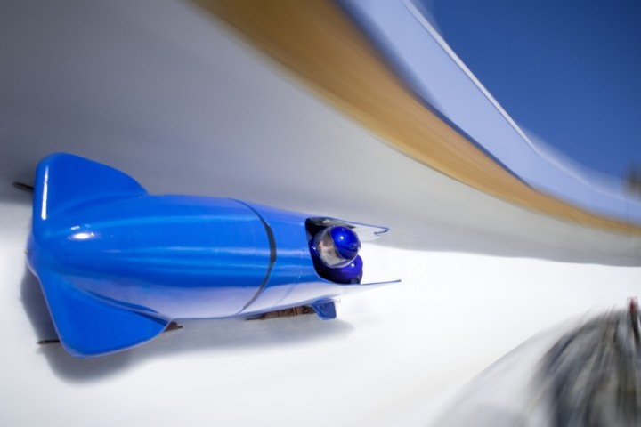 bright blue two person bobsled racing on icy track