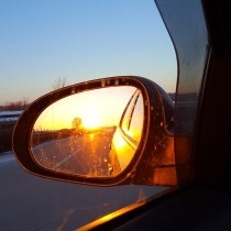 sunset reflected in car rearview mirror