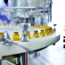 close up of brown glass bottle production line