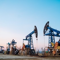 several oil pumps on a clear sky