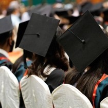 row of college graduates with caps and gowns