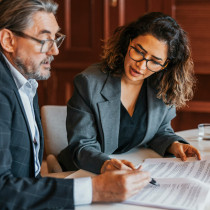 male and female business professionals examing document
