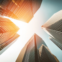 skyscrapers reaching towards sunlit sky