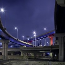 multiple highway off-ramps against dark blue sky
