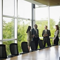 coworkers standing in conference room