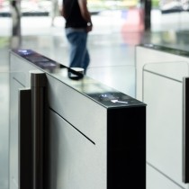 A man walks past a pair of electronic turnstiles
