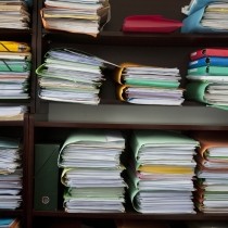 stacks of multicolored client files in lawyers office