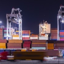 brightly colored shipping containers on dock at night