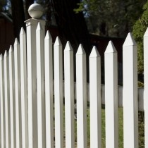 tall white picket fence in suburban yard