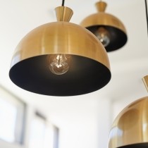 three brass pendant lights hanging at different levels