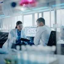 two scientists in lab discussing results