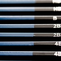 stacked set of blue and black pencils