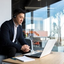 asian male executive in office on video conference