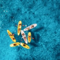 aerial view of seven kayaks on clear blue water