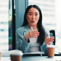 female board director engaged in conversation in conference room