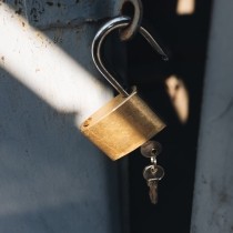 medal padlock with two keys on old garage door