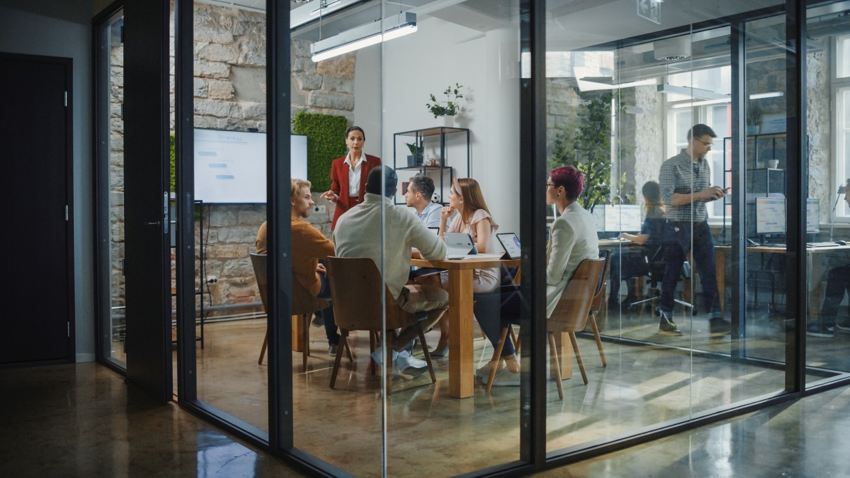 private company executives meeting in glass conference room