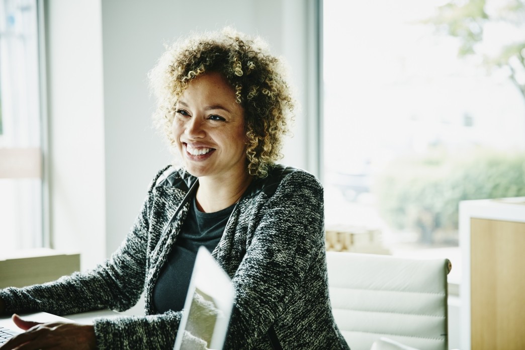 smiling businesswoman in meeting with clients