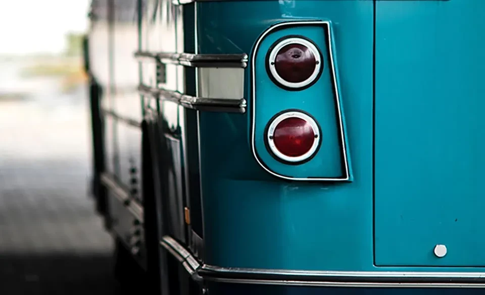 vintage turquoise microbus with red tail lights