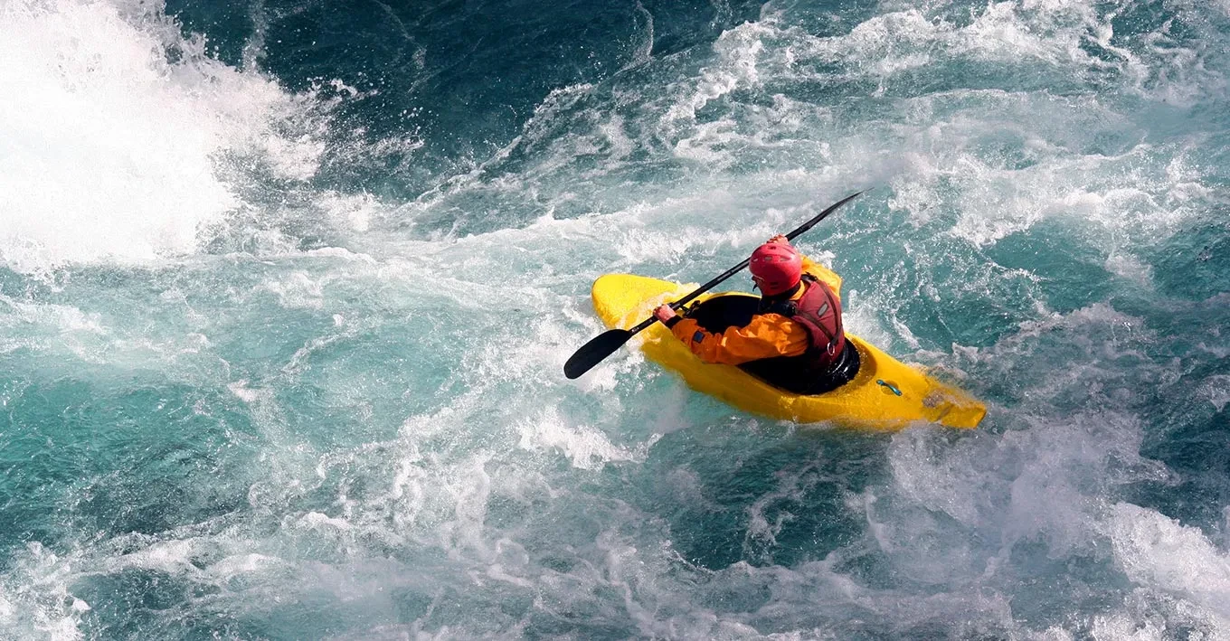 Image of a man on a canoe doing rafting