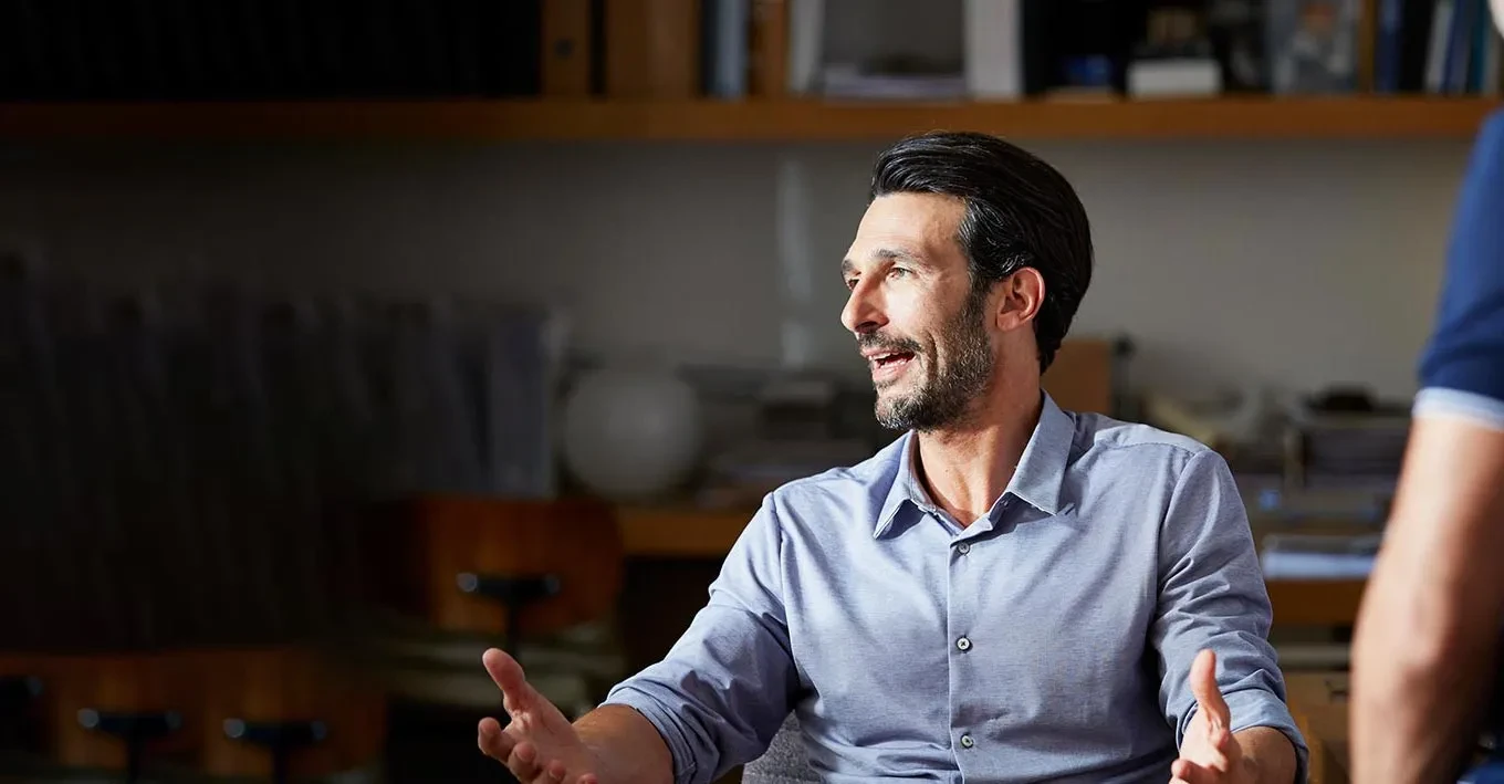 middle age man talking to a work group