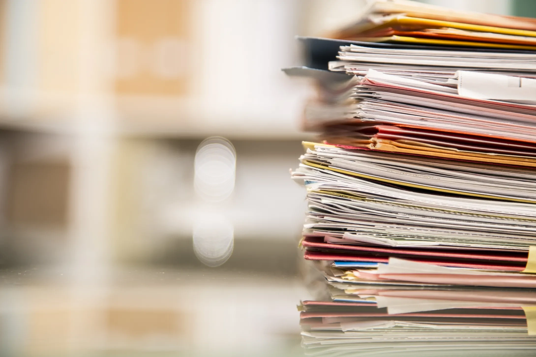 large stack of files on desk